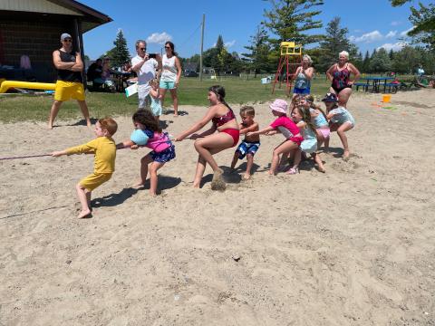 Kids playing tug of war at the morrisburg beach