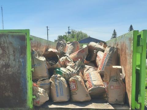 brown compost bags loaded into a bin