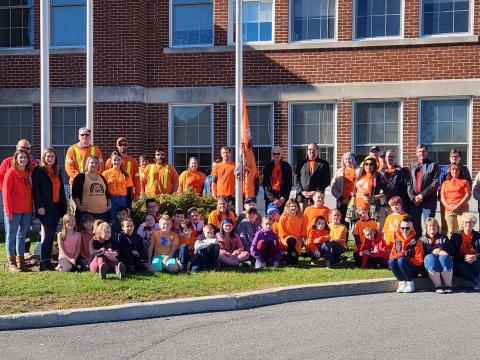 Group photo of staff and members of the public on orange shirt day