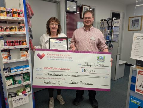 photo holding large cheque